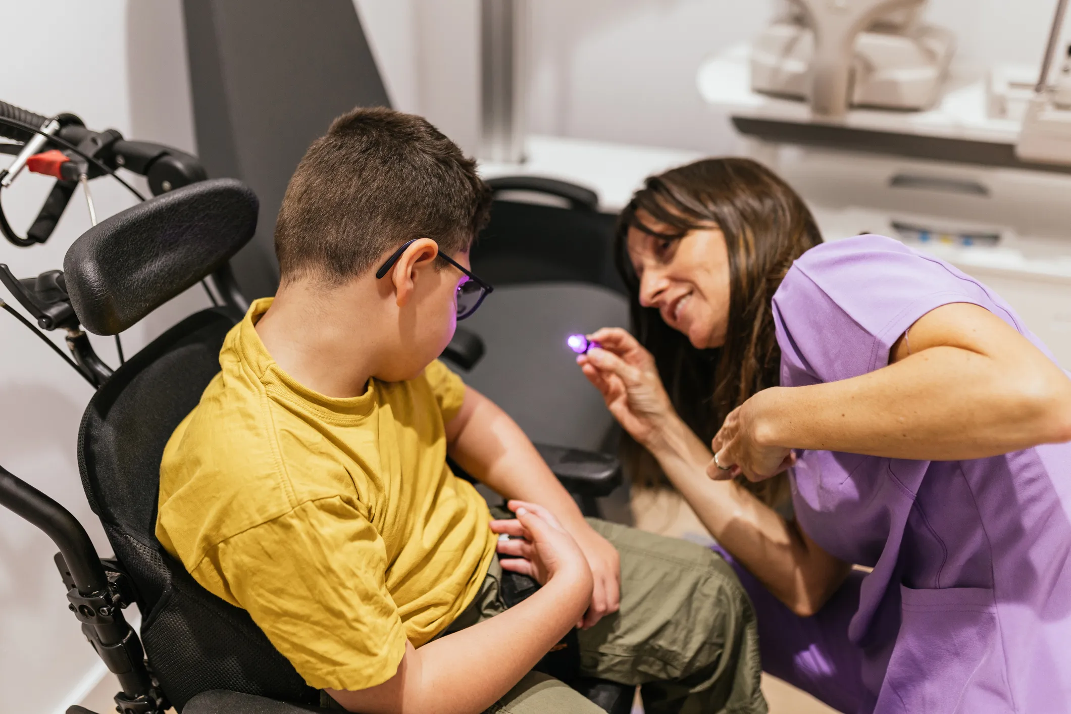 Care assistant examining a child