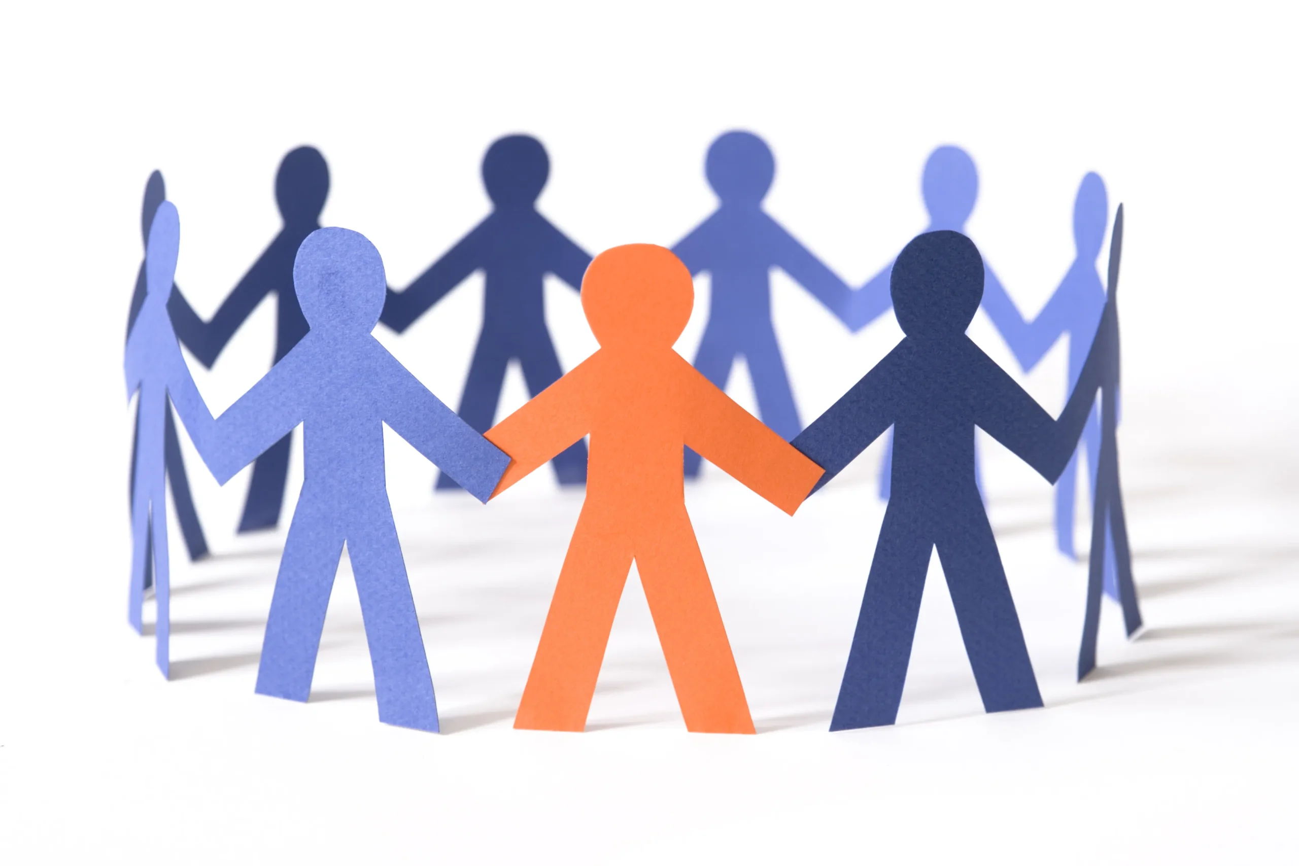 Paper cut-out figures in blue and orange holding hands in a circle