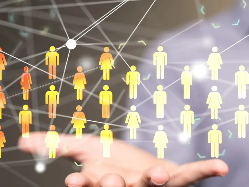 Illustration of a hand holding a network of connected human icons