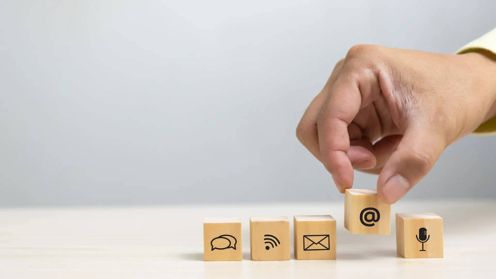 Wooden blocks with phone, mail, email, and chat icons