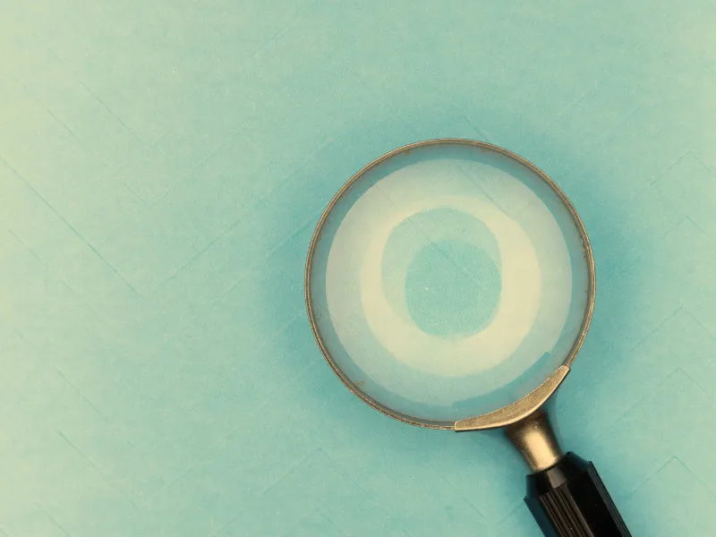 Magnifying glass on a light blue background