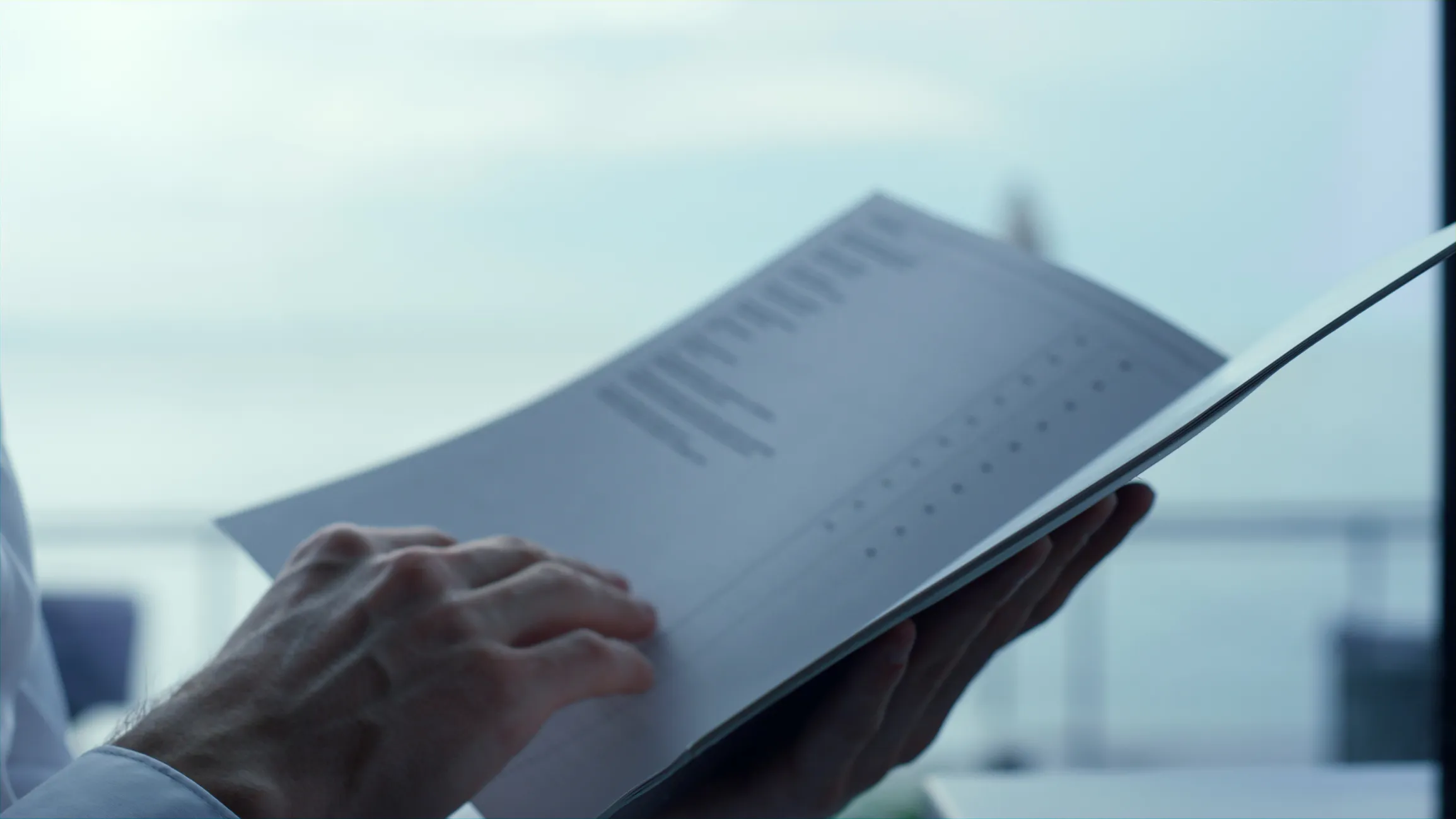 Person holding and reading a booklet