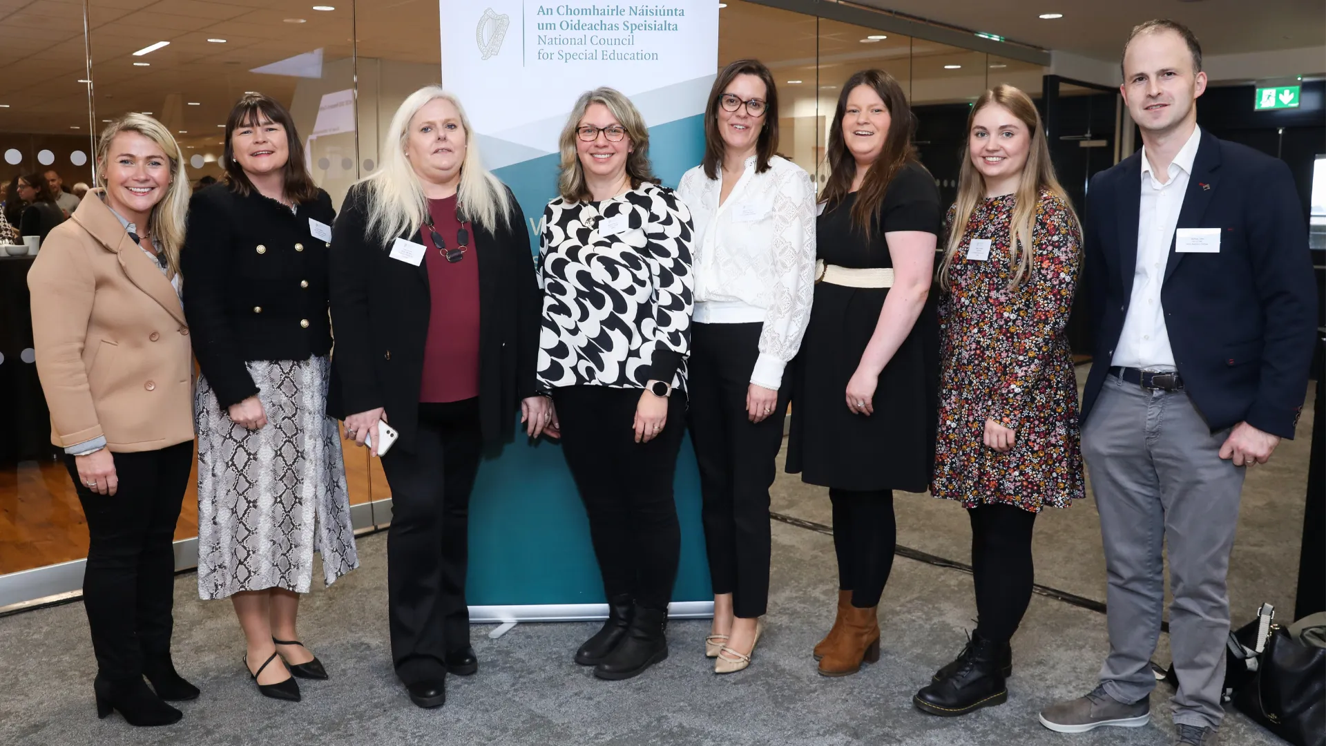 Group of people standing in front of a National Council for Special Education banner