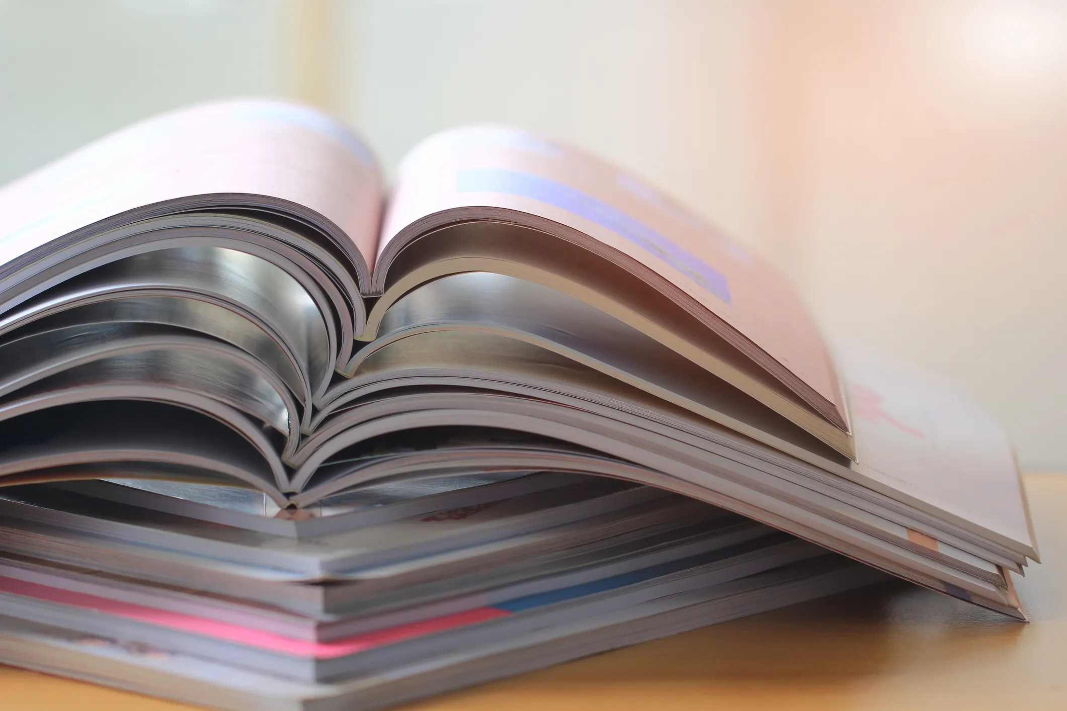 Stack of open magazines with curved pages
