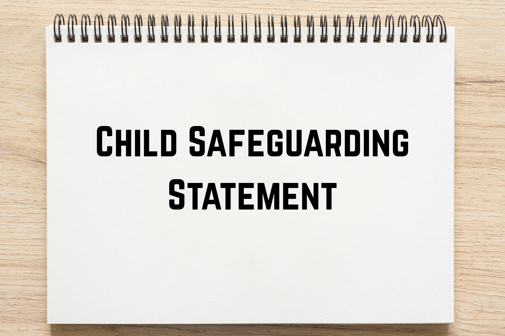 Notebook with the words "Child Safeguarding Statement" written on the page