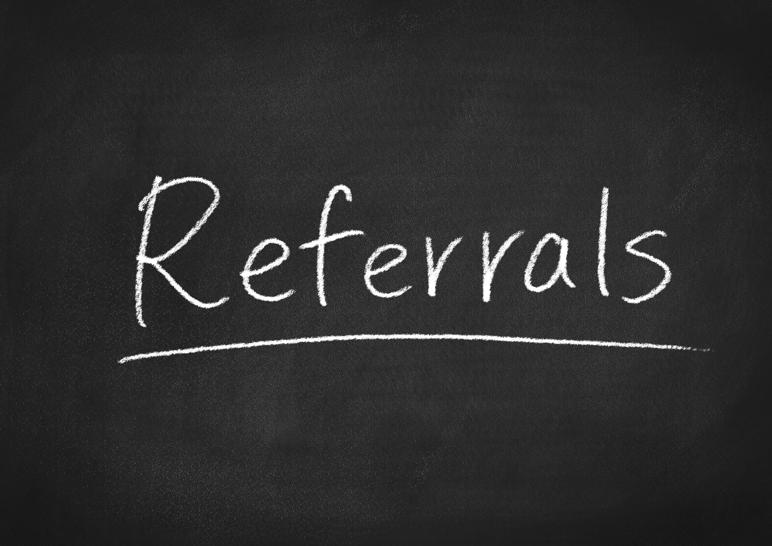 Referrals written in white chalk on a blackboard