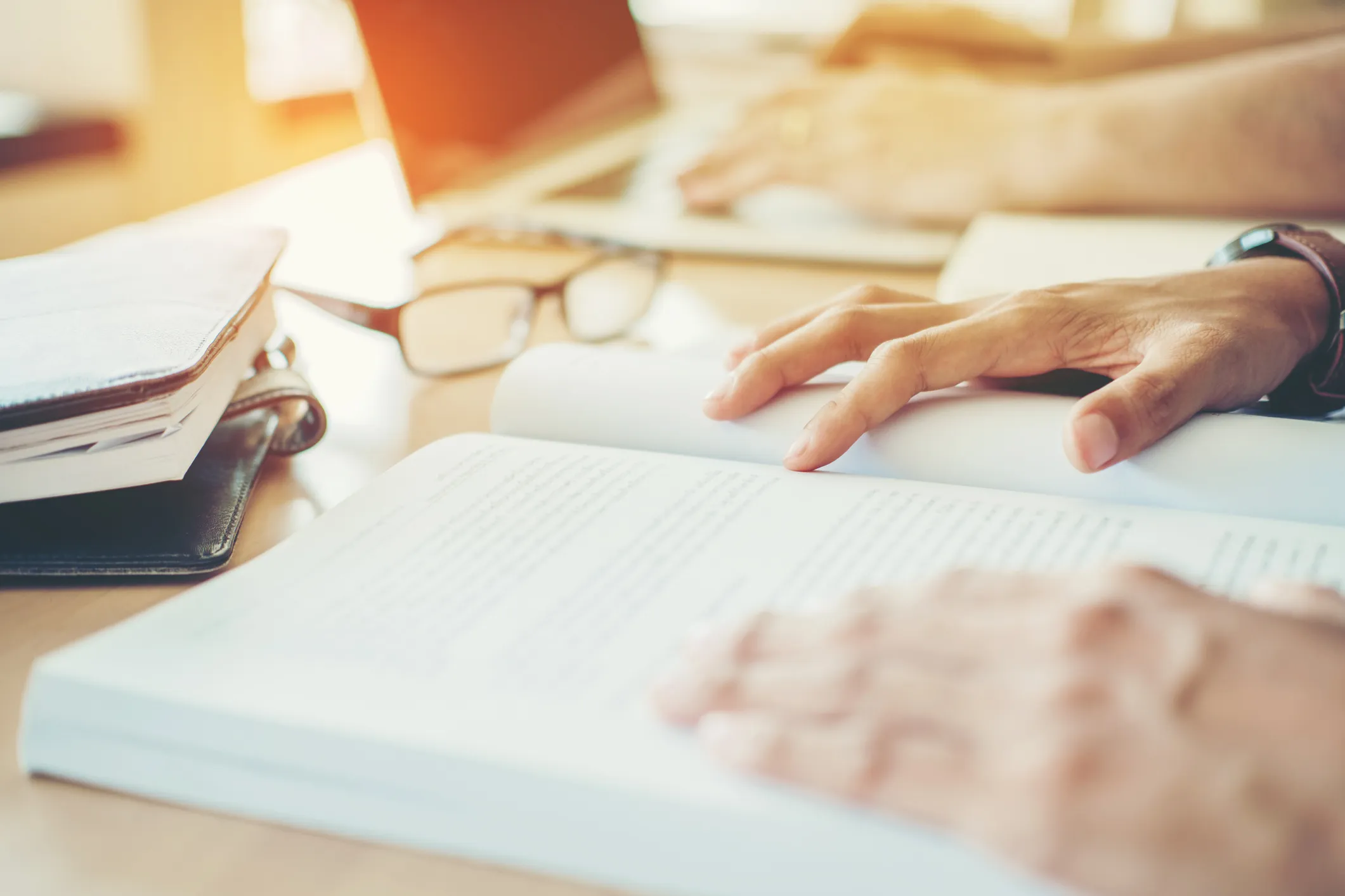 A close-up of two people working at a desk