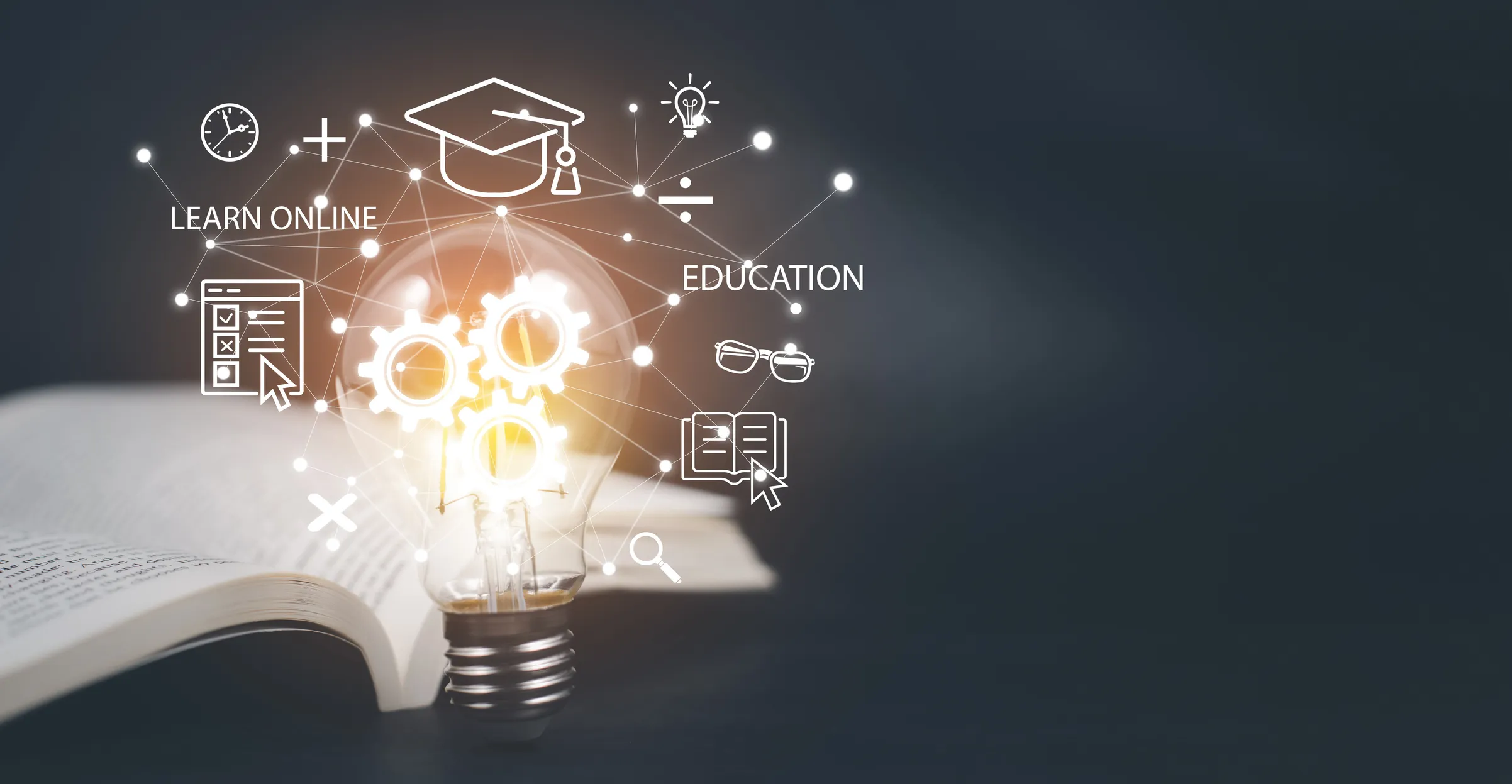 A lightbulb placed in front of an open book is surrounded by illustrated education icons, including the words LEARN ONLINE, a graduation cap, and a cursor symbol representing training courses.